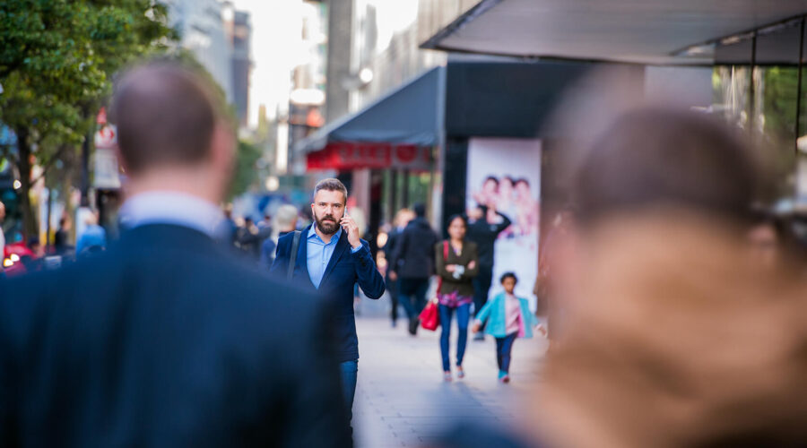hipster-manager-with-smart-phone-walking-in-the-PFKTPR9(1) Retail & Distribution